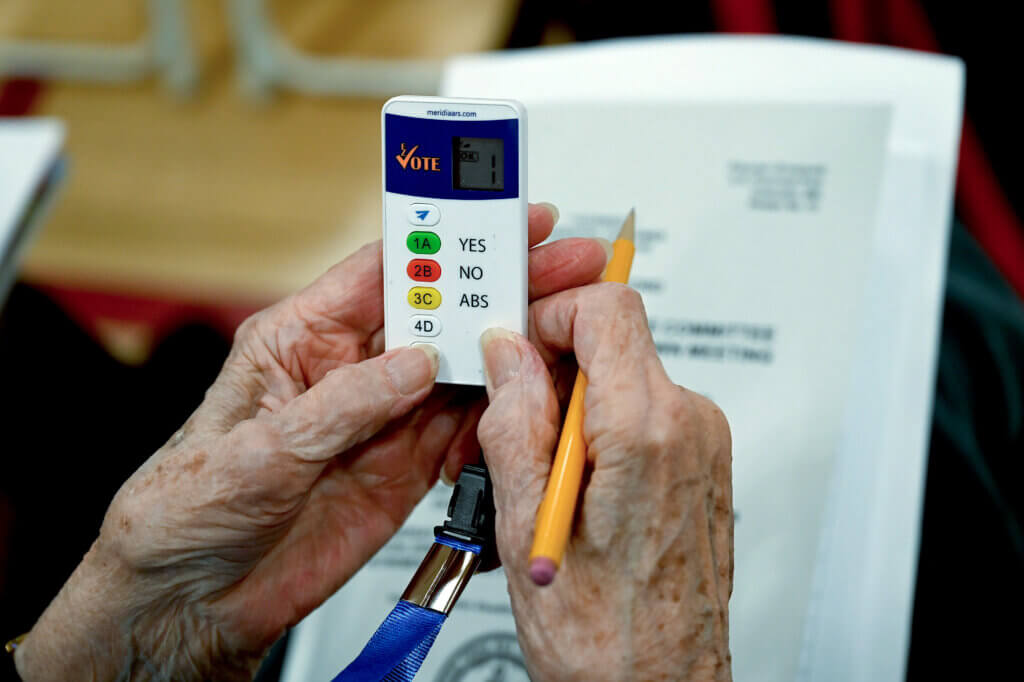 A Town Meeting voter gets her first look at a clicker. Photo: Ken McGagh/The Acton Bridge