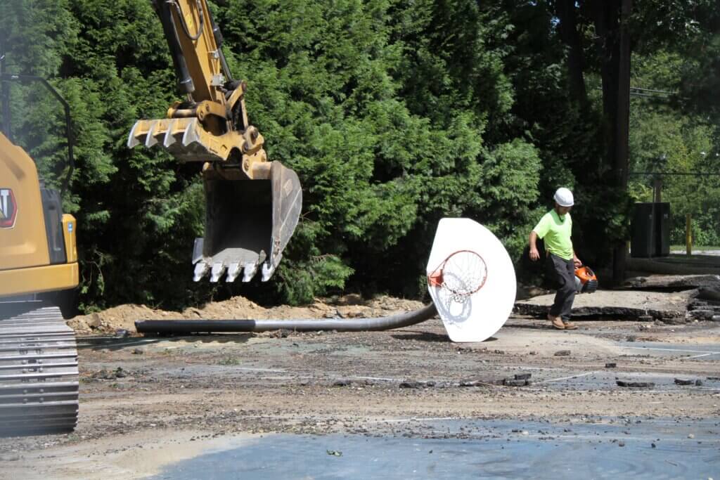 Crews used an excavator to knock over a basketball hoop at the soon-to-be-replaced Rideout recreation courts. Photo: Dakota Antelman/The Acton Bridge
