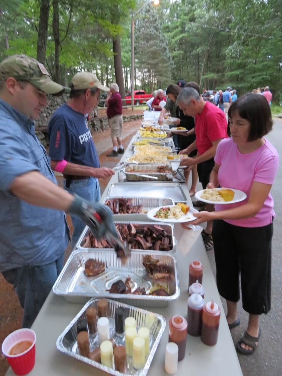 Members serve fellow members at the annual barbecue. Photo courtesy of the Acton Rod & Gun Club