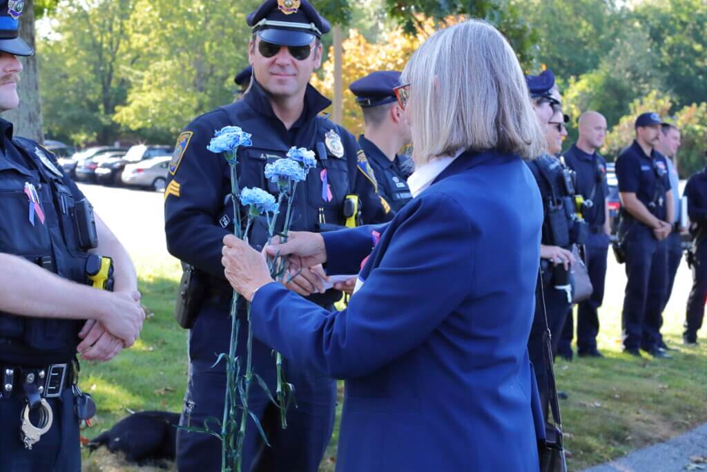 The Rotary Club gave each first responder in attendance a blue carnation. Photo: Trace Salzbrenner/The Acton Bridge