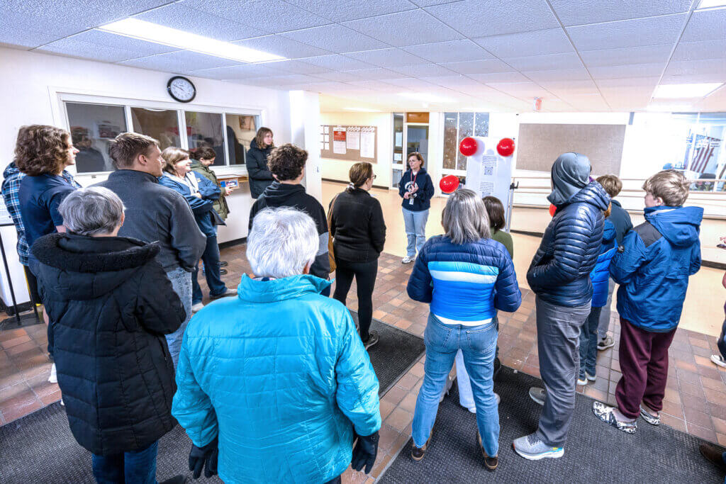 Schools Superintendent Laurie Hunter speaks to visitors at the beginning of a “Surplus Day” event at the Sanborn school. Photo: Stephen Beyer/The Acton Bridge