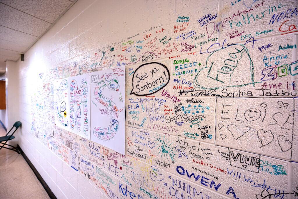 Handwritten messages from students mark part of the wall at the Sanborn school. Photo: Stephen Beyer/The Acton Bridge