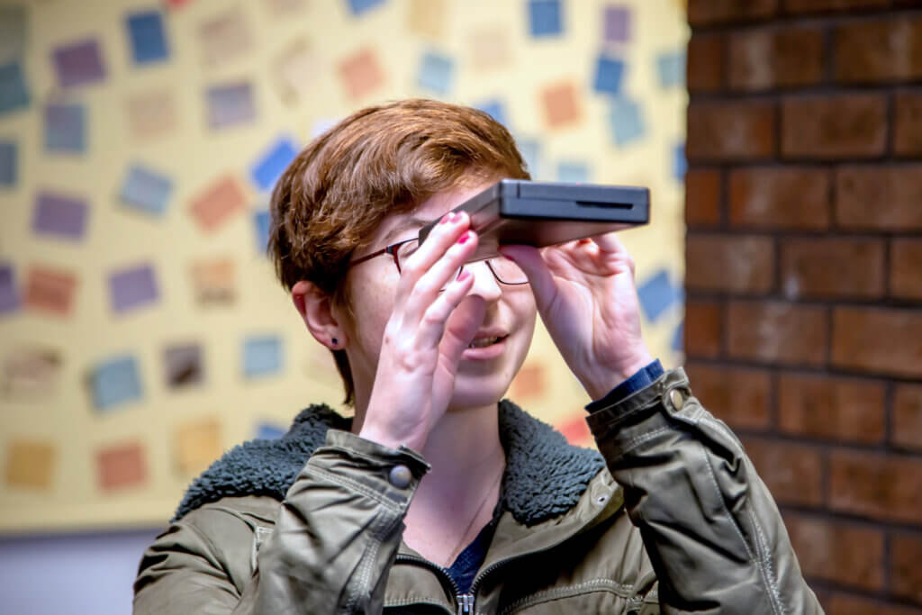 Devon Brown looks through a spectroscope they found at the Peabody school. Photo: Stephen Beyer/The Acton Bridge