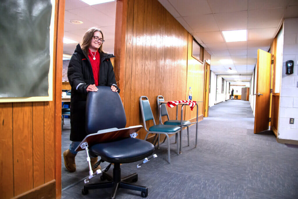 Anne Remington pushes a chair out of a teacher’s lounge in the Peabody school. Photo: Stephen Beyer/The Acton Bridge