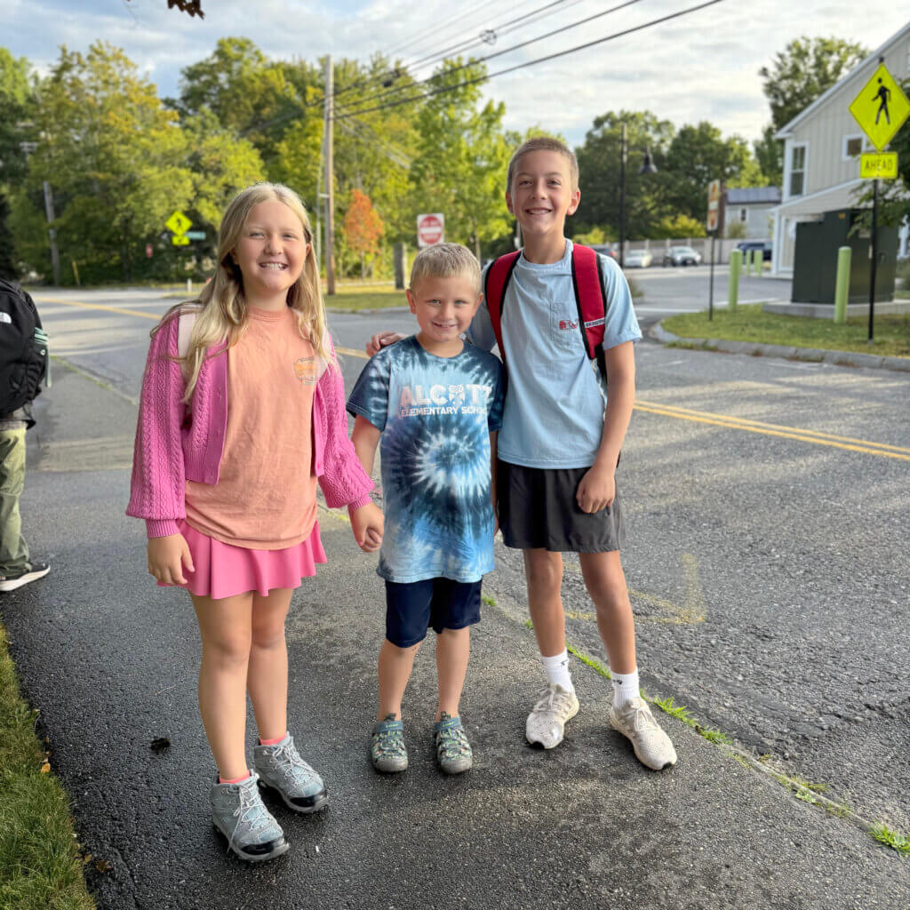 Joe and Evangeline Russell, in eighth and sixth grade respectively, pose with their Alcott “buddy” Jacob, a third grader, who came to wish them good luck.