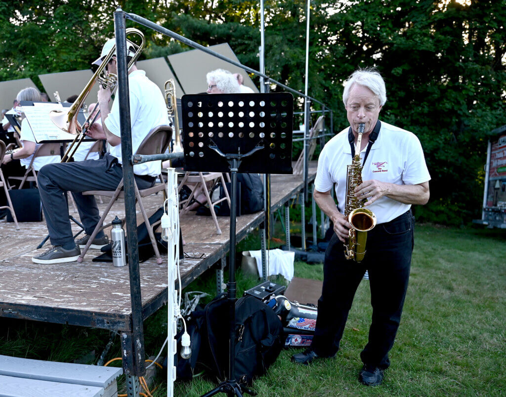 Alto saxophone player Dan Shields warms up before the band’s final summer concert. Photo: Ken McGagh/The Acton Bridge