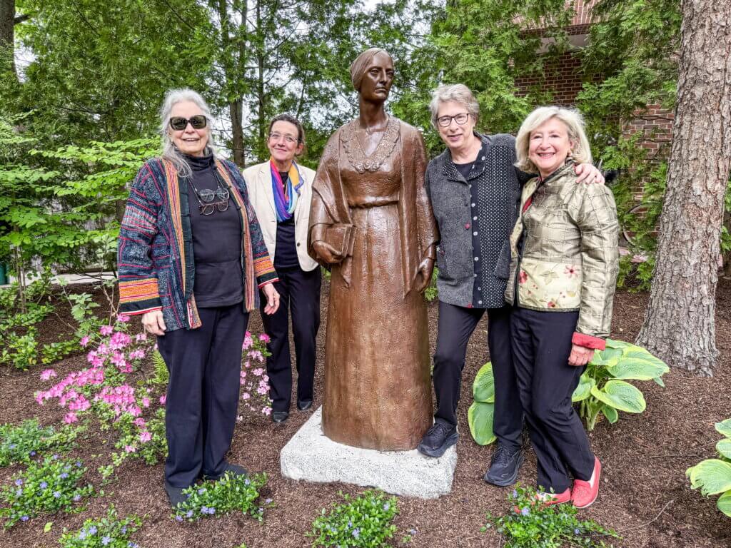 At the unveiling of a bronze of Margaret Fuller on May 23, left to right, are sculptor Penelope Jencks; Anke Voss, curator, William Munroe Special Collections; Fuller biographer Megan Marshall; and Sherry Litwack, trustee, Acton Free Public Library Association. Laurie O’Neill/The Acton Bridge