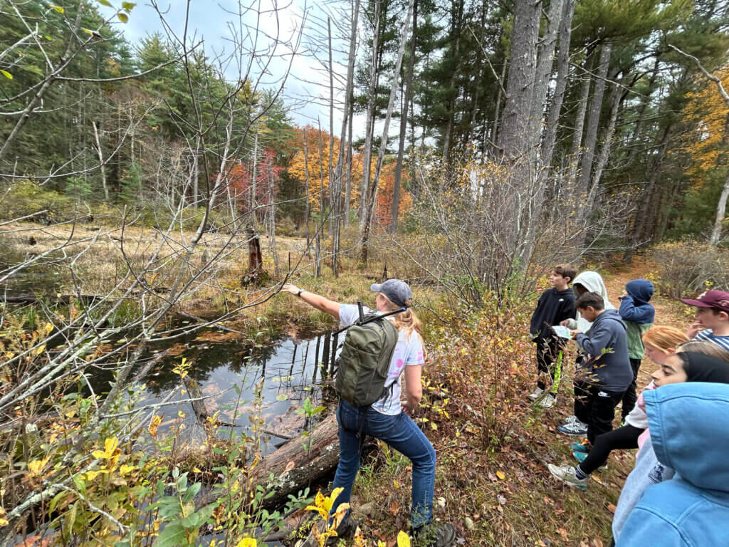 Cara McElroy of Zoo New England shows members of Jonathan Smith’s fourth grade class the turtle habitat near Punkatasset Hill. Photo courtesy of Jonathan Smith