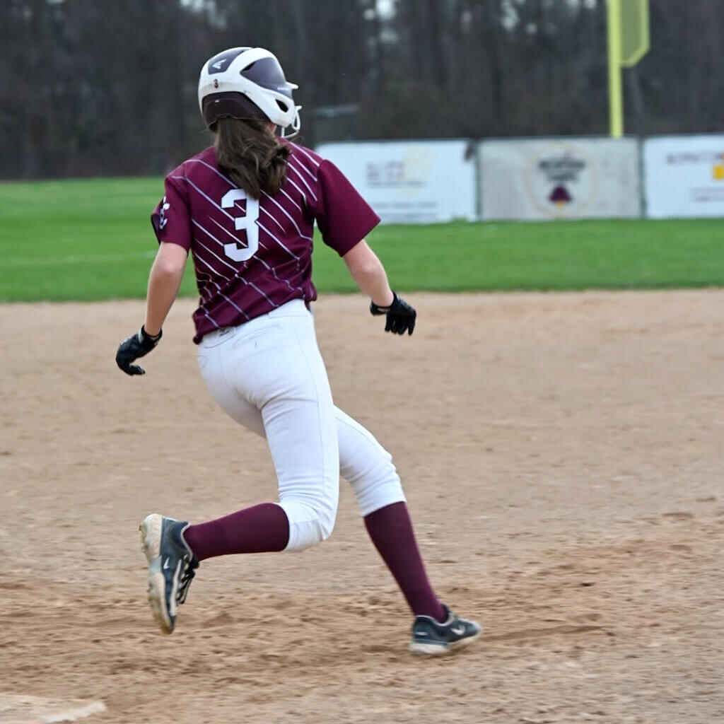 Olivia Scaduto rounds first base looking for two against Arlington Catholic on April 16. Photo by Kristin Martines