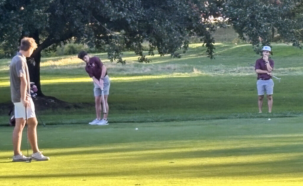 Jake Jones putts on the seventh hole at Nabnasset Country Club in Westford on September 14 as playing partner Joe Grasso and a Westford Academy opponent look on. Photo by Carl Sweeney