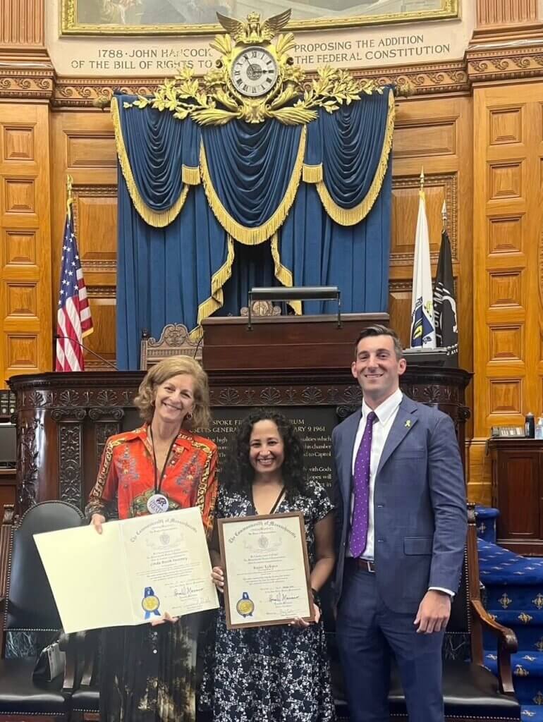 Linda Booth Sweeney, left, with Rajani LaRocca, a past book award winner, and state Rep. Simon Cataldo at the Statehouse on October 7. Courtesy photo