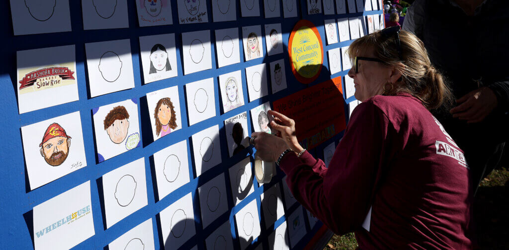 Art For All volunteer Marybeth Lee adds a drawing to the Community Quilt “We Shine Brighter Together” during Discover West Acton Day on Saturday, October 18, 2025. The completed piece will be on display at the Fowler Branch Library in November and the Scout House next year. Ken McGagh/The Acton Bridge