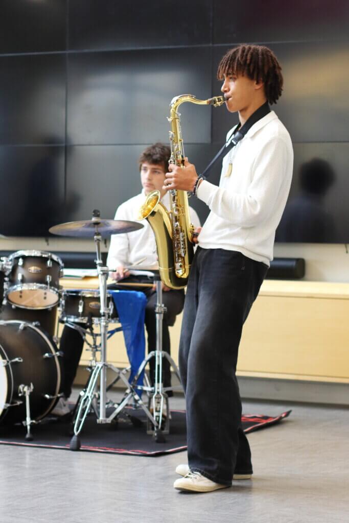 Rory Best plays the saxophone, with Max Booth on the drums. Along with Liam Parisky-Kern, they formed a three-piece band that entertained the crowd. Photo: Trace Salzbrenner/ The Acton Bridge