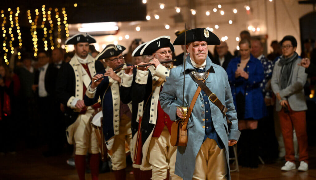 The Acton Minute Men, lead by Captain Carl Sweeney, march into the Acton Armory for the opening ceremony of the 2025 Patriots’ Ball on Saturday, April 12, 2025. Ken McGagh/The Acton Bridge