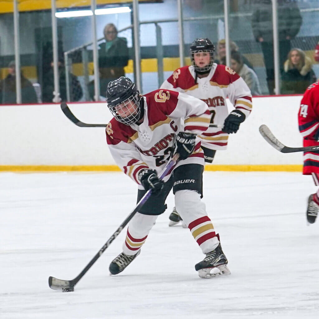Patriots co-captain Addy Healy, shown in action against Central Catholic on January 6, tallied two goals and an assist to lead the Patriots to victory against Cambridge Rindge and Latin on January 10. Photo by Tina Wu