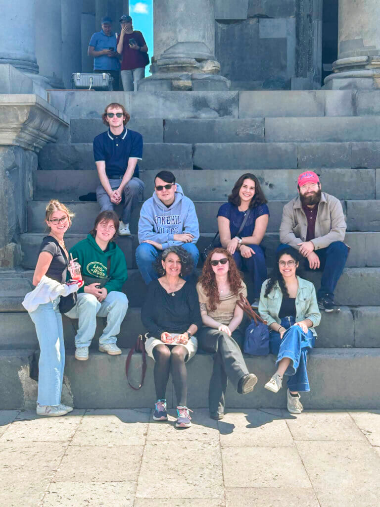 Anna Ohanyan sits with her Stonehill students at Garni Temple, the only pre-Christian monument in Armenia. Photo courtesy of Anna Ohanyan