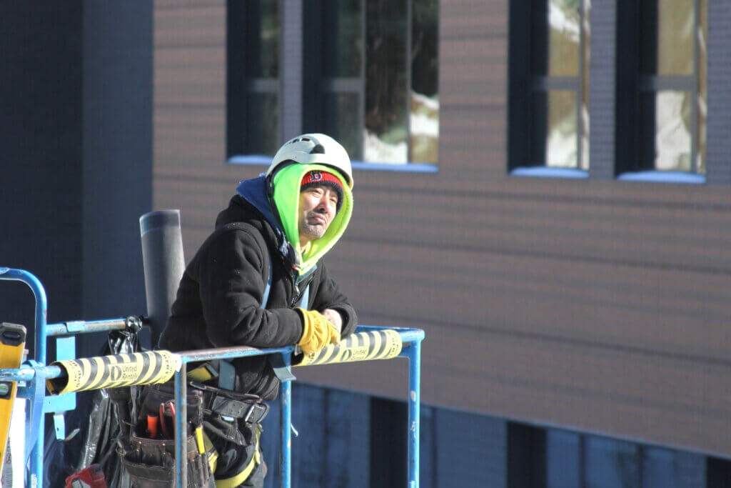 A project worker watches as visitors begin their tour. 