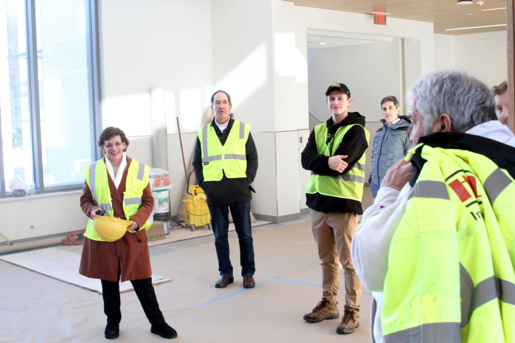 Schools Superintendent Laurie Hunter speaks with project staff inside the main entrance. 
