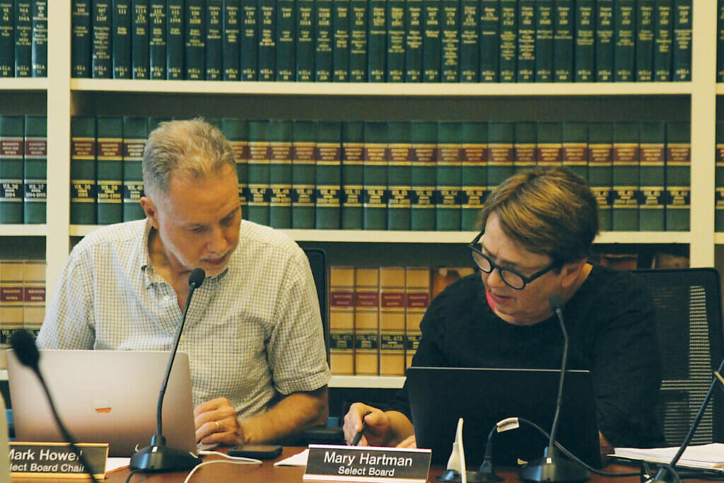Select Board Chair Mark Howell and board member Mary Hartman review the agenda before Monday’s Select Board meeting. Photo: Dakota Antelman/The Acton Bridge