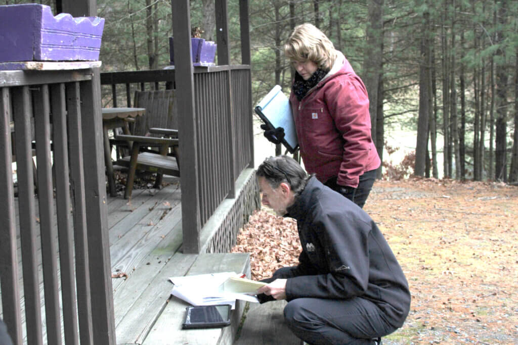 Civil engineer Phil Cordeiro discusses a set of planning documents with town planner Elizabeth Hughes. Photo: Dakota Antelman/The Acton Bridge