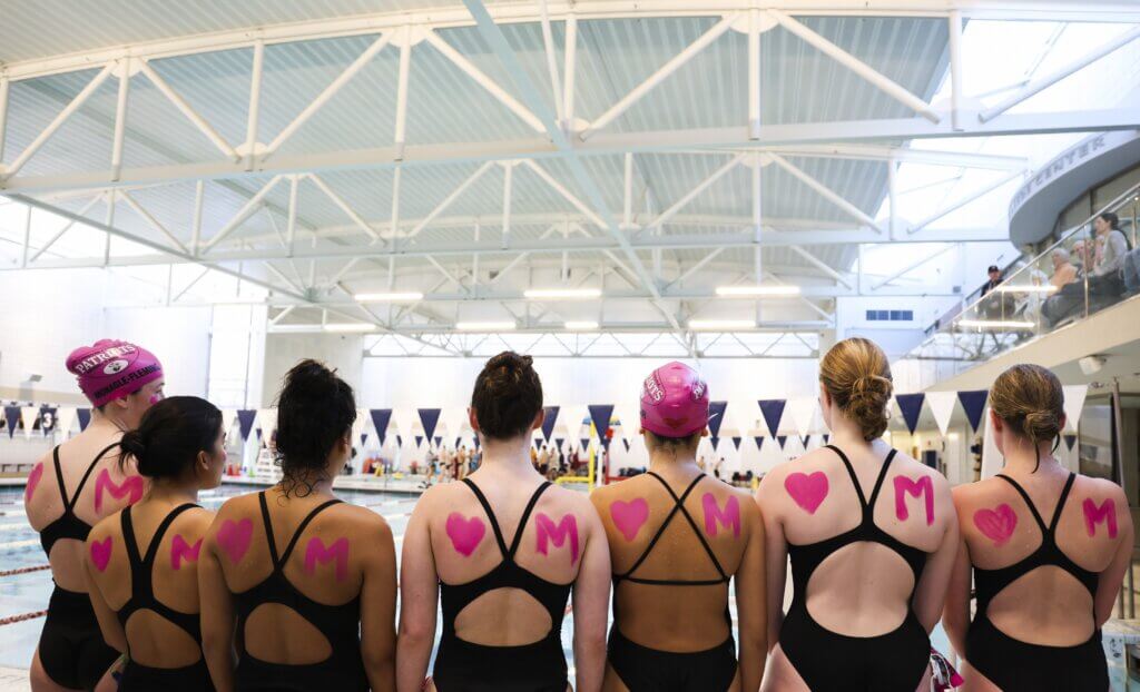 Acton-Carlisle swimming and diving team members honored Maisey O’Donnell with body paint and specially made caps at the January 21 meet. Photo by Kate Renyi