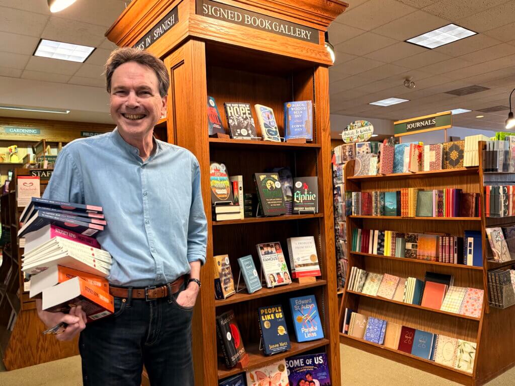 Manager John Netzer of Acton Bookshop, which offered a galley grab — free advanced reader copies — for Third Thursday. Photo by Elisabeth Weber