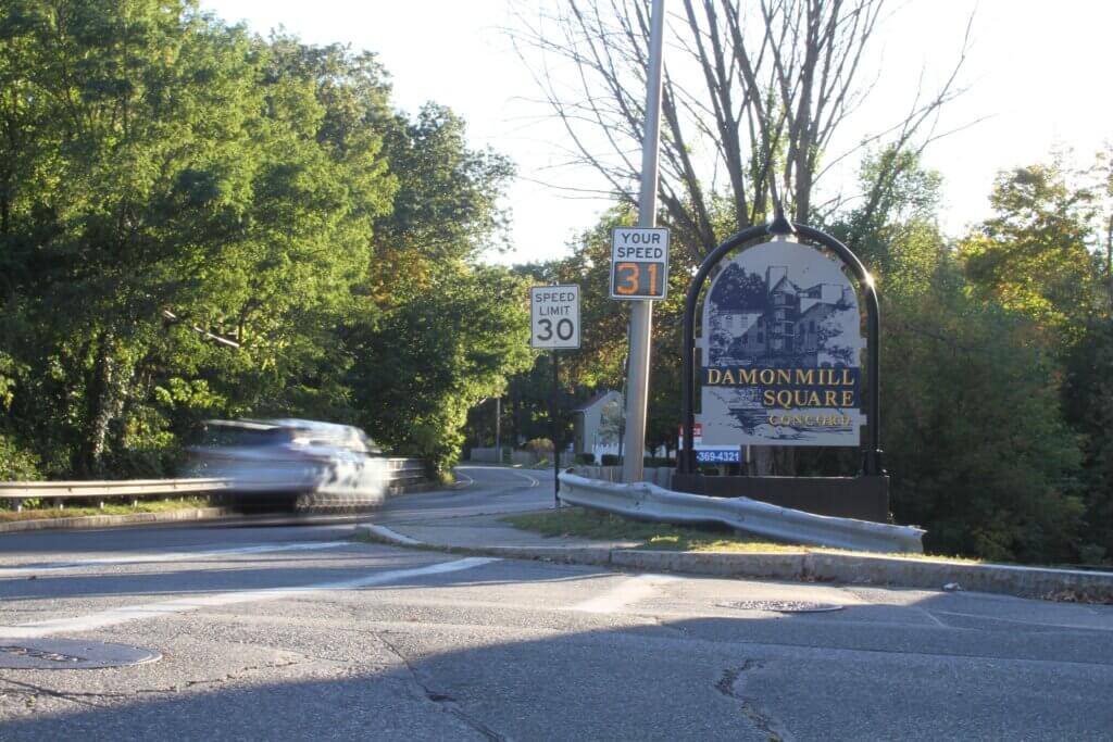 A car zips past Damonmill Square in West Acton. Photo: Dakota Antelman/The Acton Bridge