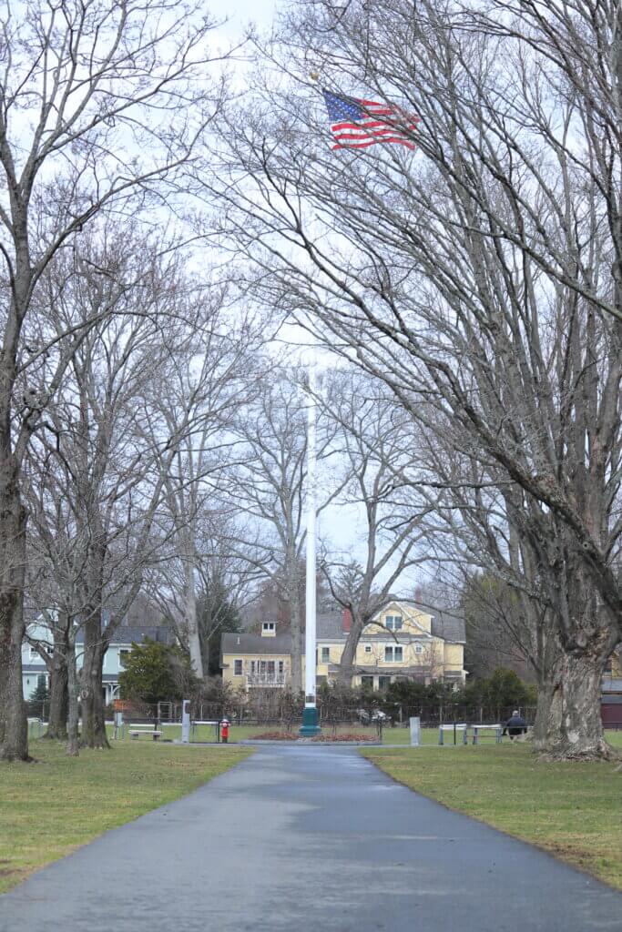 Rebecca Purcell says that, more than anything, it’s the trees that show the passage of time, as they look much older than when she started caring for the flag. Photo: Trace Salzbrenner/The Acton Bridge