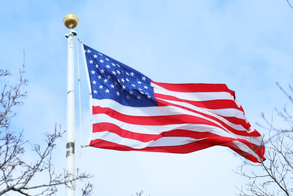 Michael Rudd says the flags at Emerson Field have been made of different fabrics over the years: The original banners were cotton, nylon flags followed, and now they are polyester. Photo: Trace Salzbrenner/The Acton Bridge
