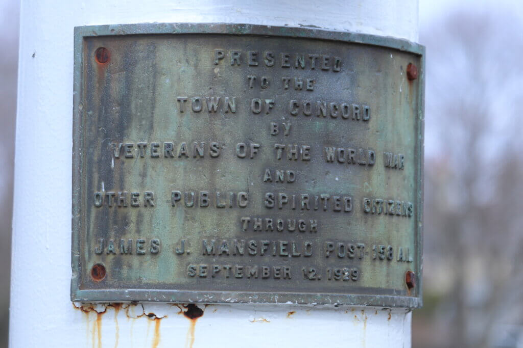 A plaque attached to the flagpole at Emerson Field. Photo: Trace Salzbrenner/The Acton Bridge