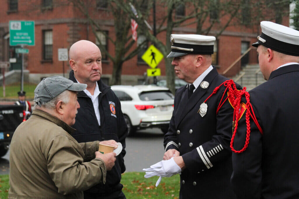 Former Select Board Chair Henry Dane, left, speaks with Fire Chief Brian Whitney and Fire Capt. Sean Murphy.