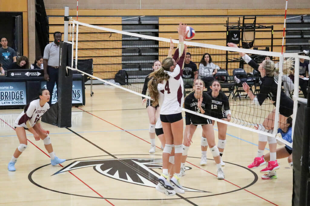 Patriots Summer Simek (No. 4) and Sadie Constable leap to thwart a Falcons attack on September 15. Photo by Debra Antonangeli
