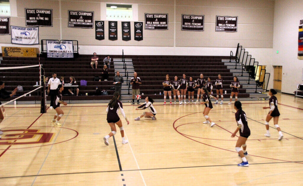 Senior libero Layli White (white jersey) passes a Shrewsbury serve on September 3. Photo by Debra Antonangeli