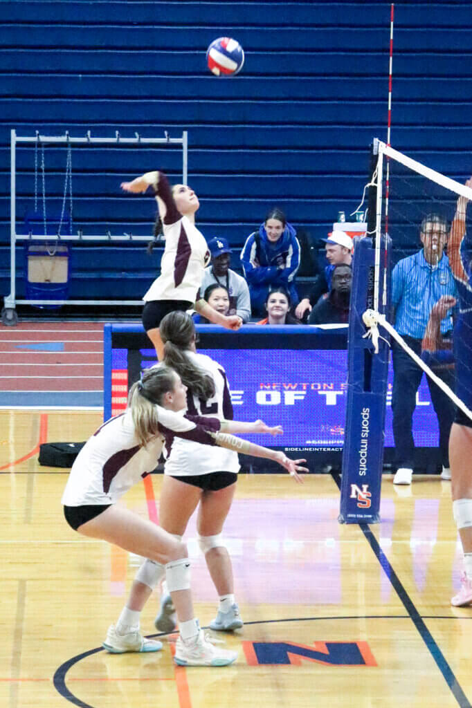 The Patriots’ Bella Cuozzo winds up for a spike against Newton South on October 7. Photo by Debra Antonangeli