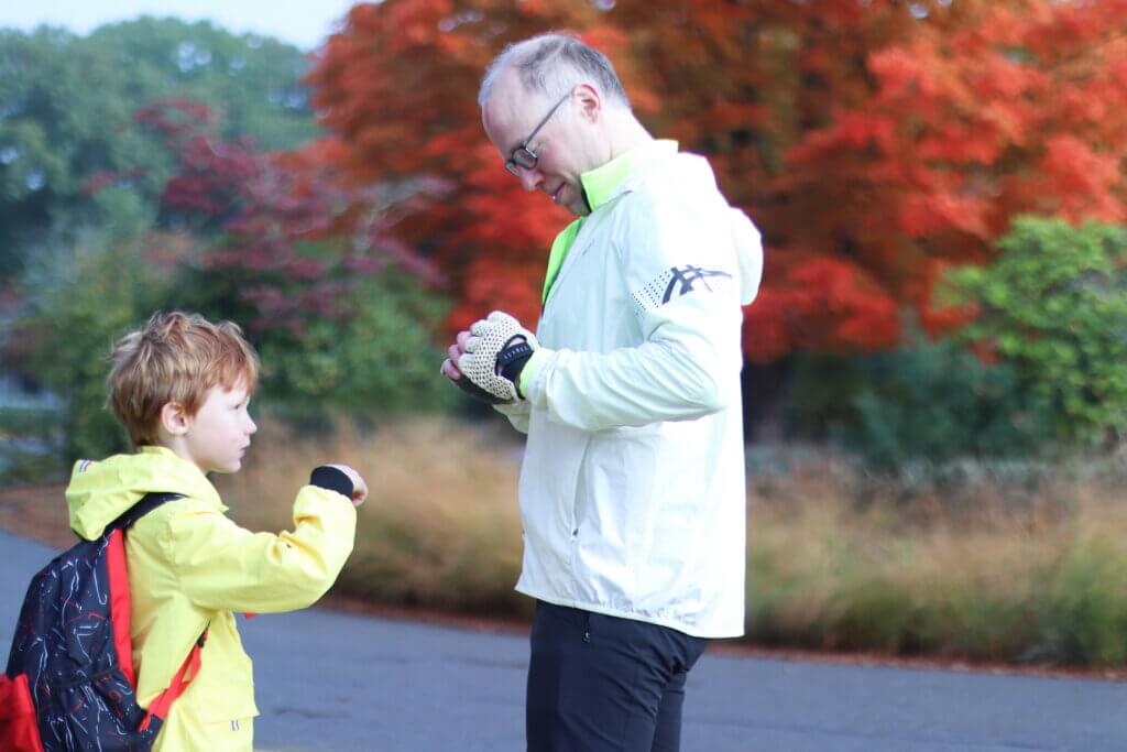Joe Cockriel helps his son George, 6, put on a Safe Routes to School sticker. Photo: Trace Salzbrenner/The Acton Bridge