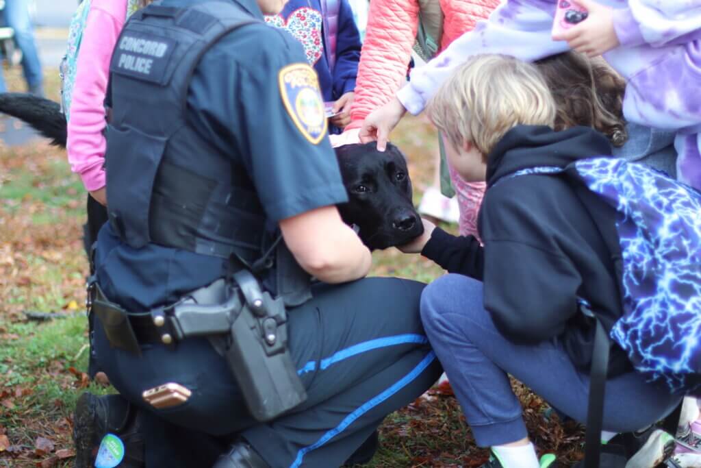 Students bestow appreciative pats and pets on Acton Police comfort dog Thor. Photo: Trace Salzbrenner/The Acton Bridge