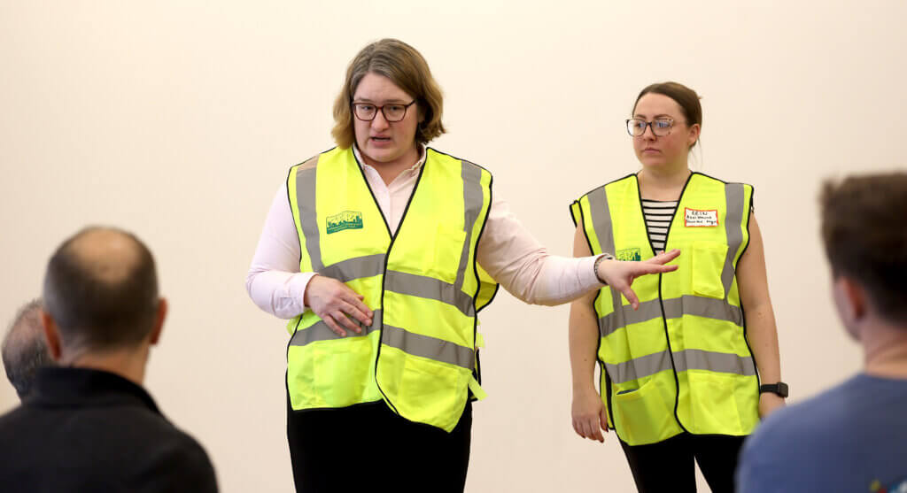 Public Health Director Melanie Dineen, left, and Erin McMorrow, of Acton human services, acting as shelter manager and assistant shelter manager, talk to first responders. Photo: Ken McGagh/The Acton Bridge