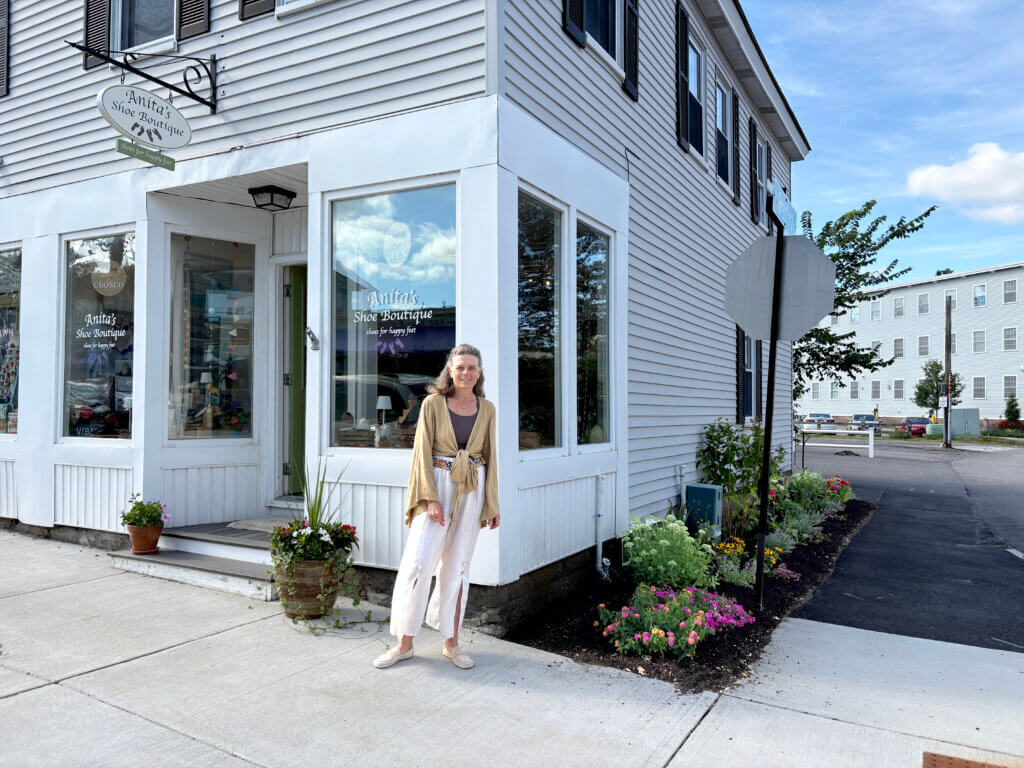 Anita Opitz outside her shoe store on Commonwealth Avenue, with her finished garden. Photo: Christine M. Quirk/The Acton Bridge