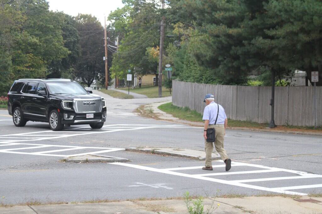 A man crosses Baker Avenue at its intersection with Main Street. Photo: Dakota Antelman/The Acton Bridge