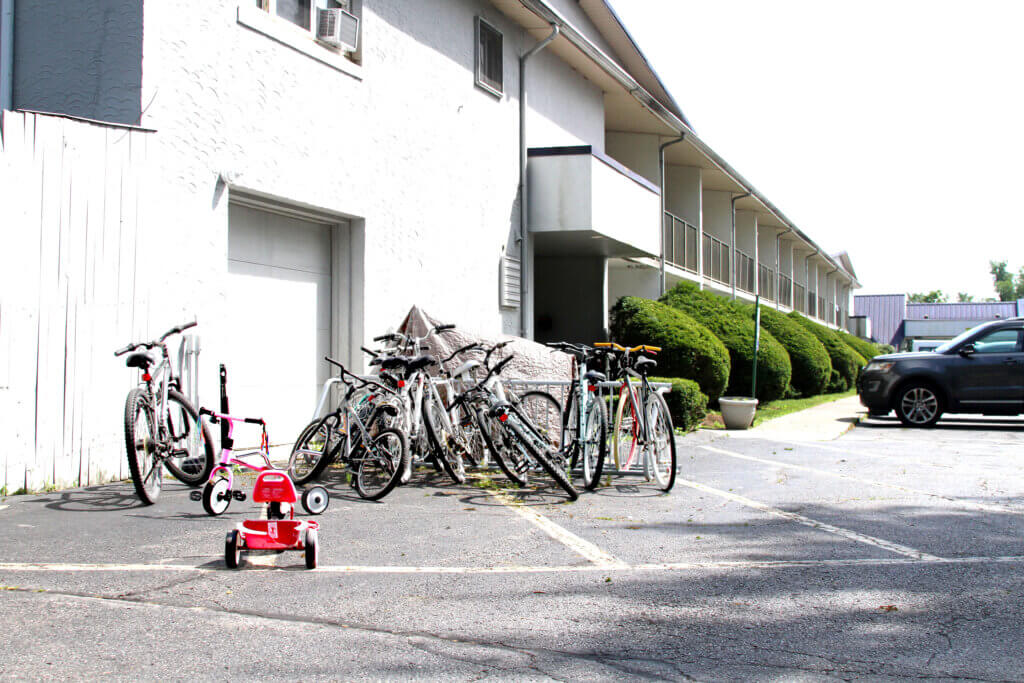 Bicycles sit clustered around a bike rack at the hotel-turned-shelter on Elm Street in late June. Photo: Dakota Antelman/The Acton Bridge