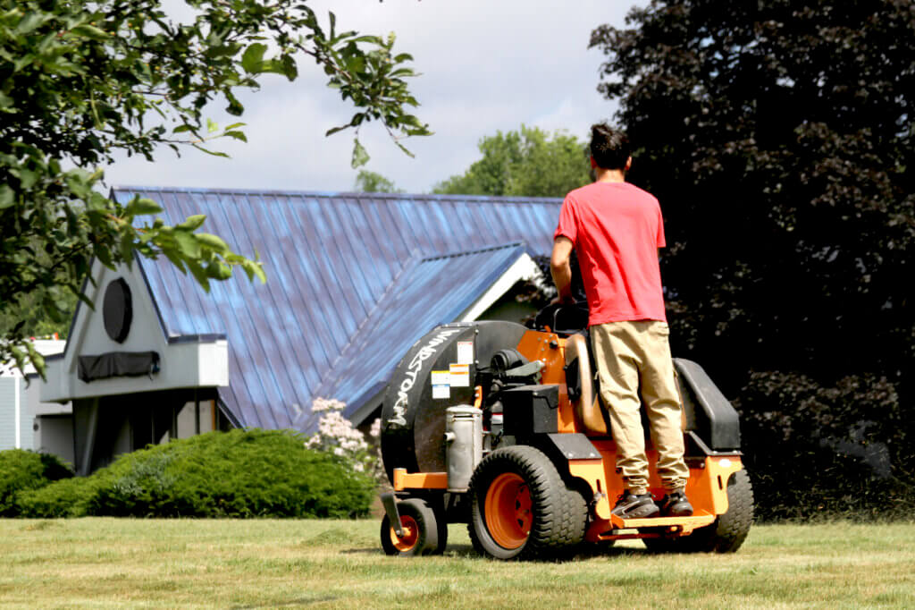 A worker mowed the lawn as the state prepared to end shelter operations at the site. Photo: Dakota Antelman/The Acton Bridge