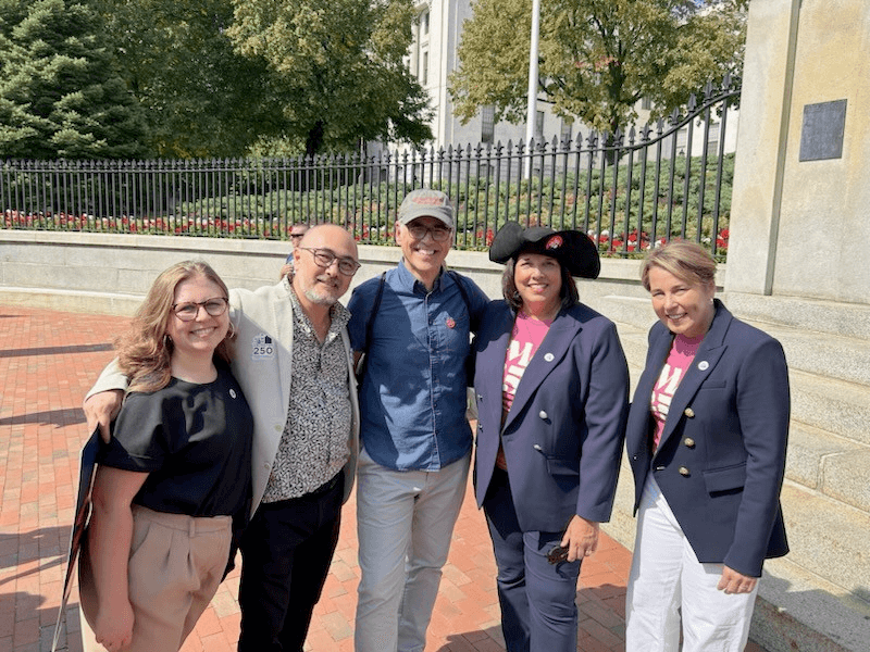 At the State House, left to right: Katie Luczai of Arlington250, Concord250 Communications and Publicity Subcommittee member Stewart Ikeda, DEI Commission co-chair Joe Palumbo, Lt. Gov. Kim Driscoll, and Gov. Maura Healey. Courtesy photo