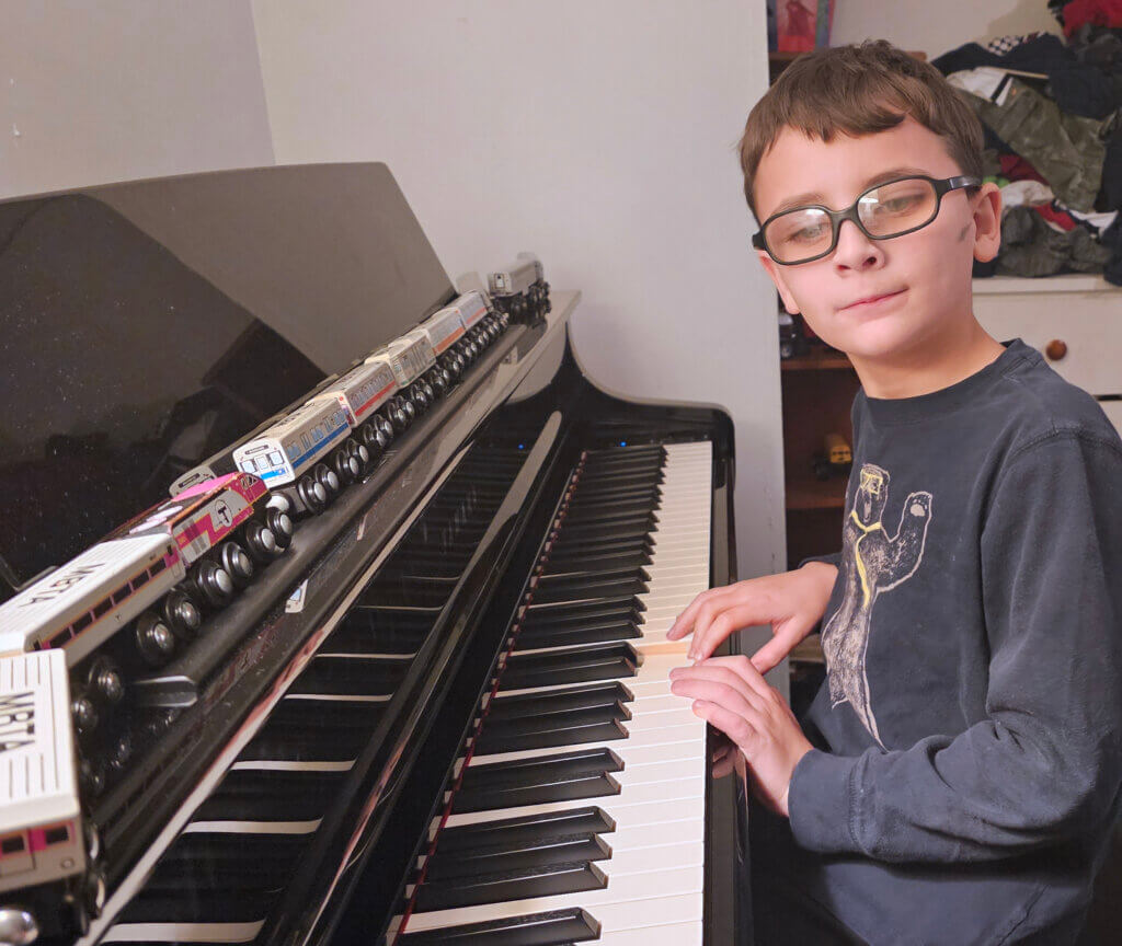 George Taylor practices piano in his Acton home. Courtesy photo