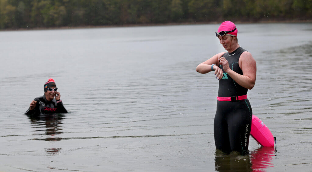 Open water swimmers Emily Macomber of Woburn and Trish Babb of Milton emerge from the water at Walden Pond on Wednesday, May 13, 2026. Ken McGagh/The Acton Bridge