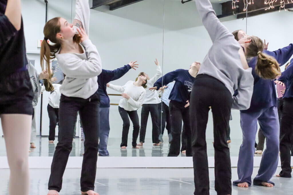 Dancers practice in front of a large mirror to help them perfect movements. Photo: Trace Salzbrenner/The Acton Bridge